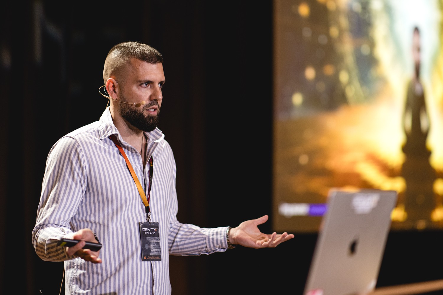 Dawid speaking on stage at Devoxx Poland in 2024